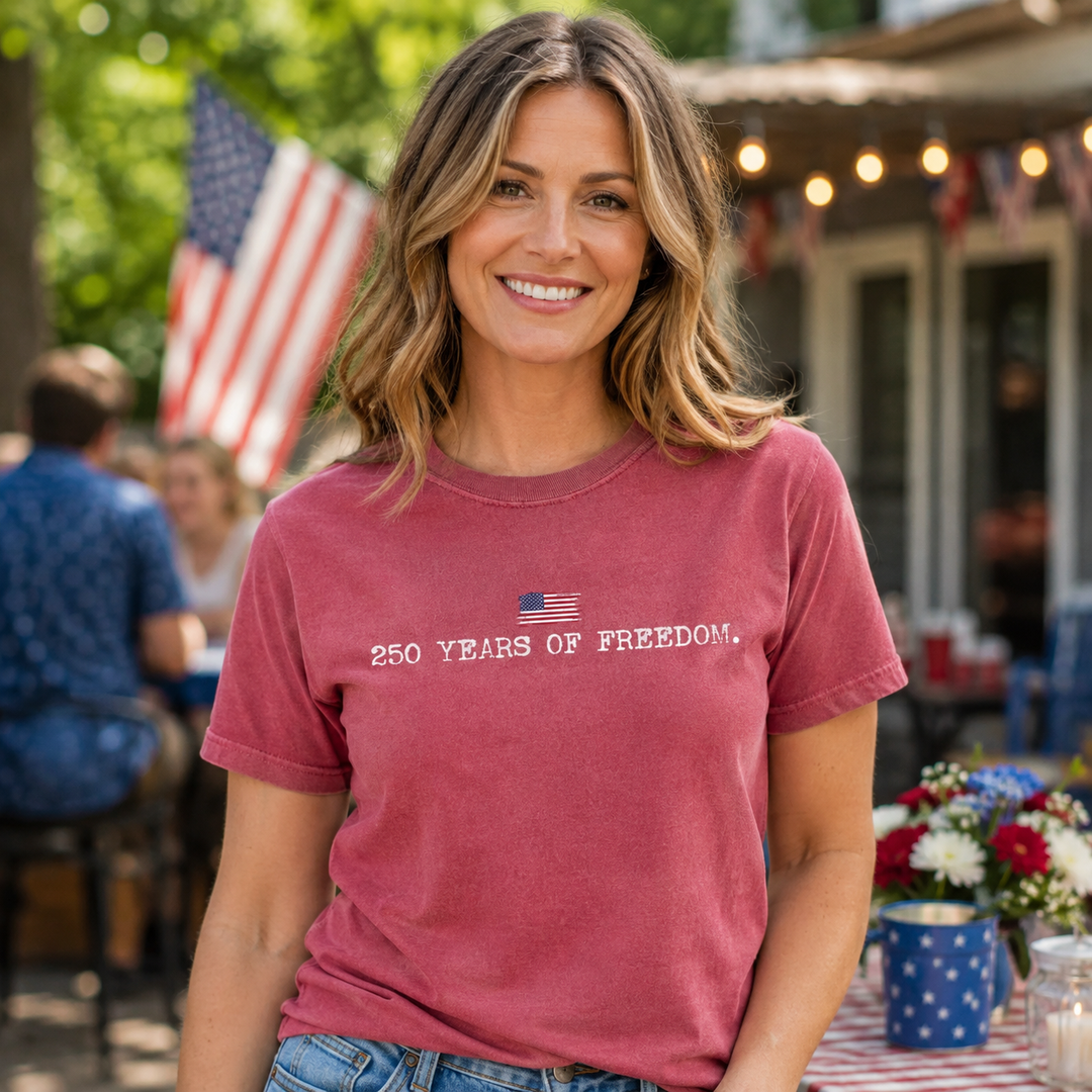 Woman wearing a true-to-size 250 Years of Freedom crimson patriotic graphic tee at a summer celebration