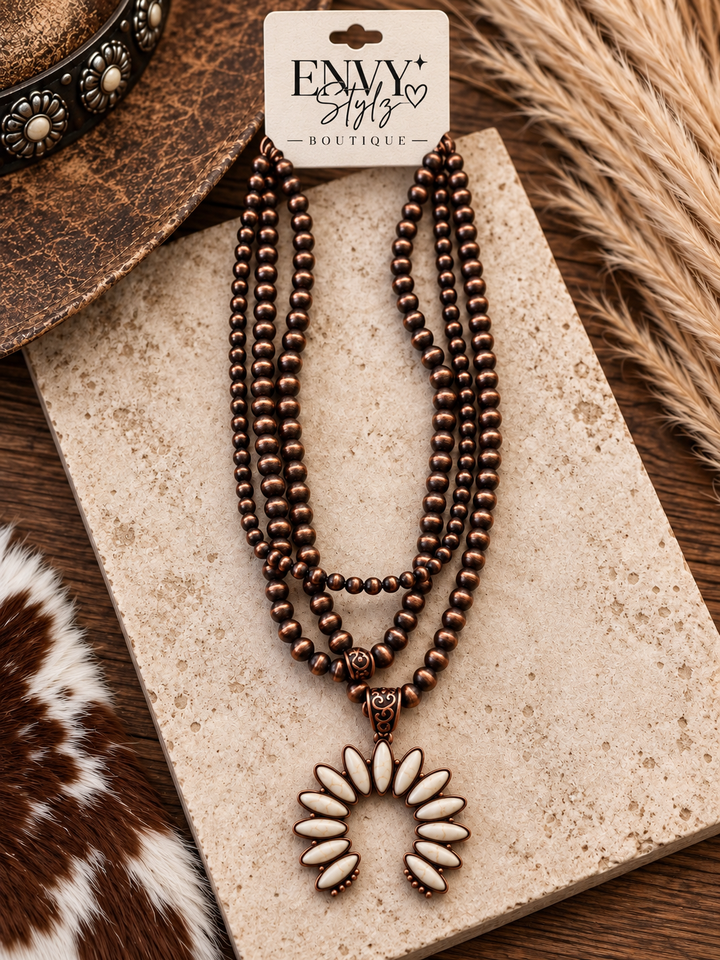 Desert Ivory Squash Blossom Necklace with antique copper-tone pearl strands and ivory pendant