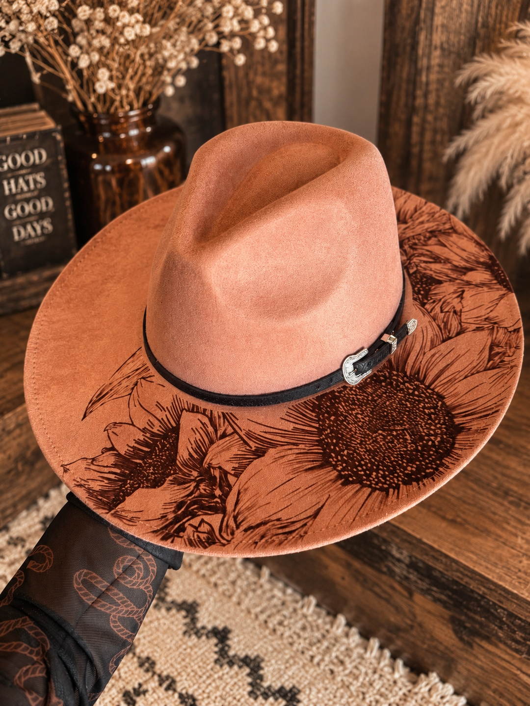 Top view of the dusty rose Sunset Bloom Western hat with sunflower brim artwork and black band