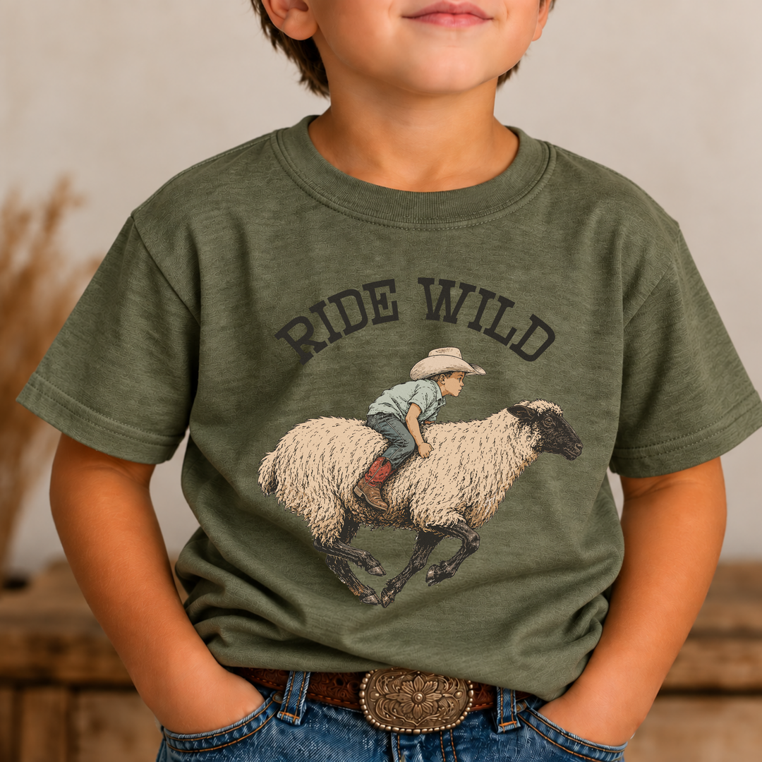 Ride Wild military green boys graphic tee with a vintage sheep-riding cowboy