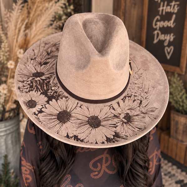 Woman wearing the taupe Wild Daisy Western hat with floral brim design and dark band
