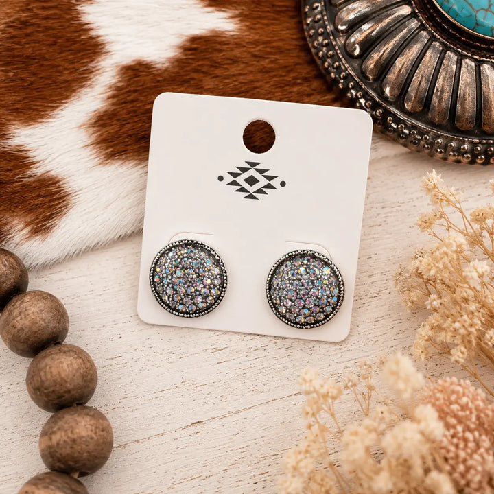 Silver-tone round stud earrings filled with iridescent rhinestones