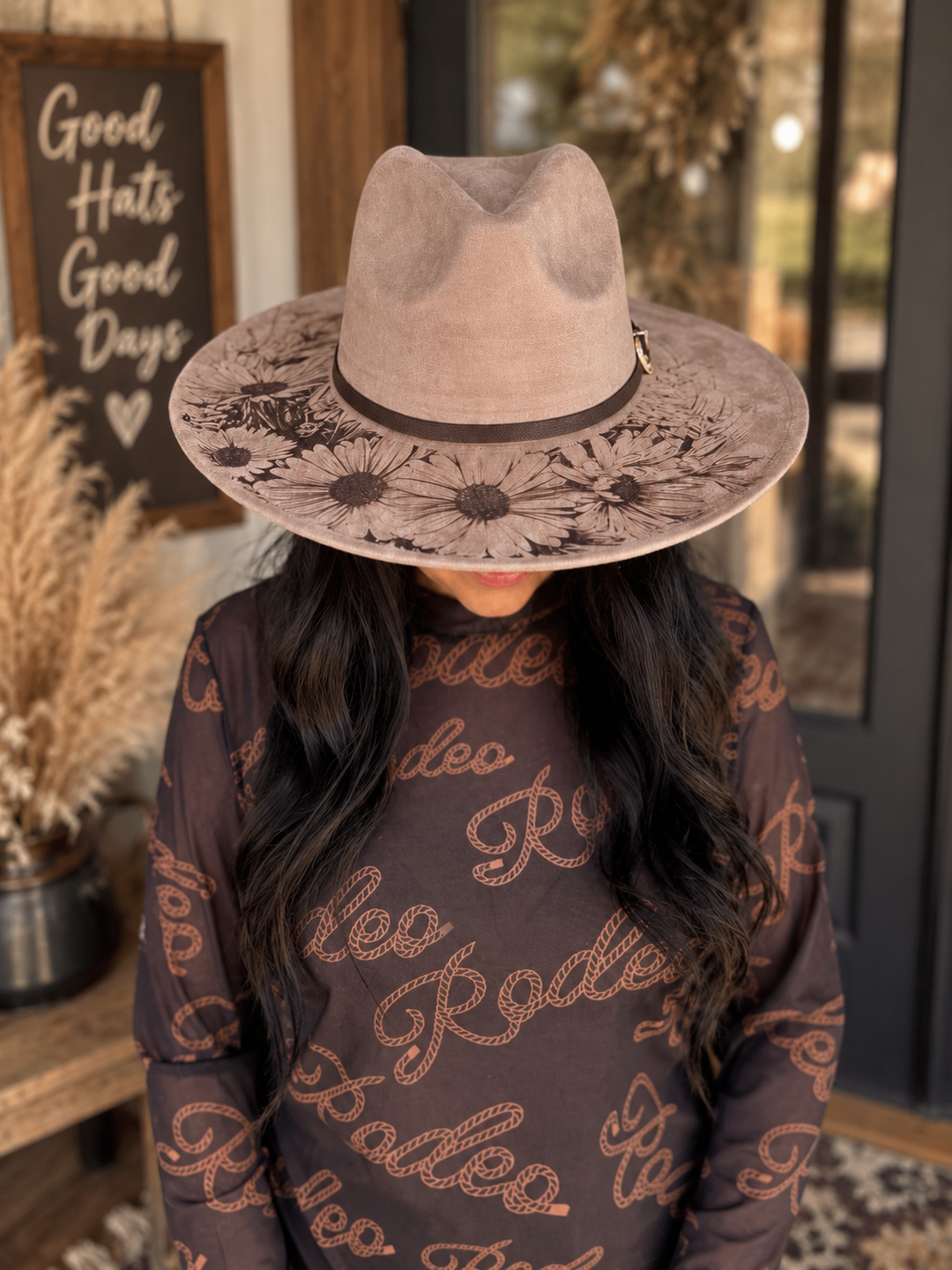 Angled front view of a woman wearing the Wild Daisy Western hat with daisy artwork