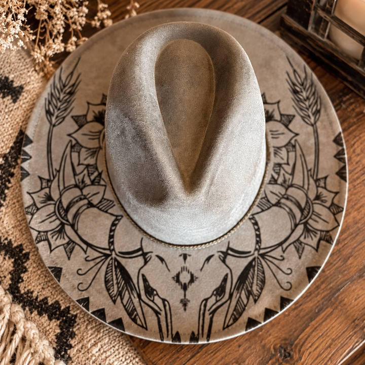 Top view of the gray Wildflower Outlaw wide-brim Western hat with longhorn skull and floral artwork