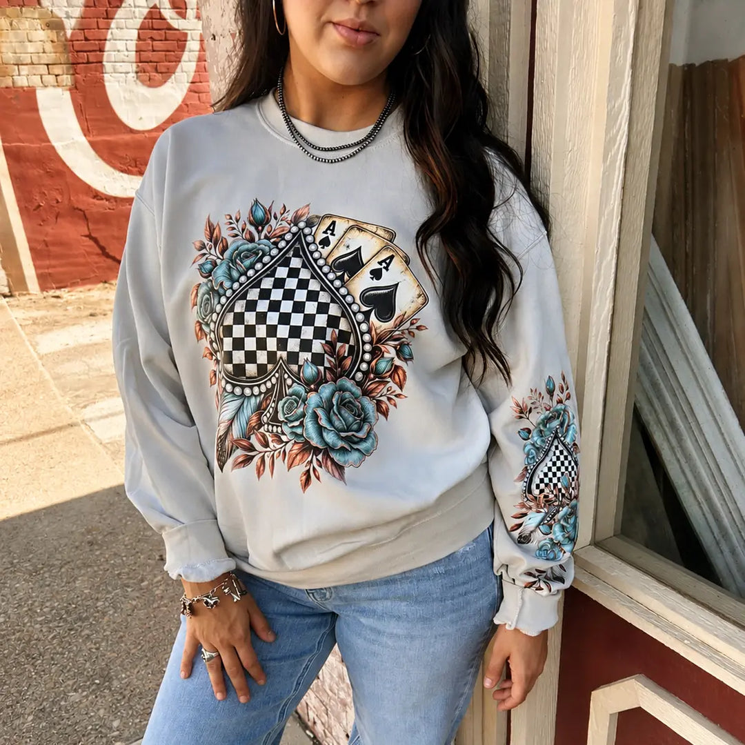 Model wearing the Floral Checkered Spade Sand graphic crewneck sweatshirt