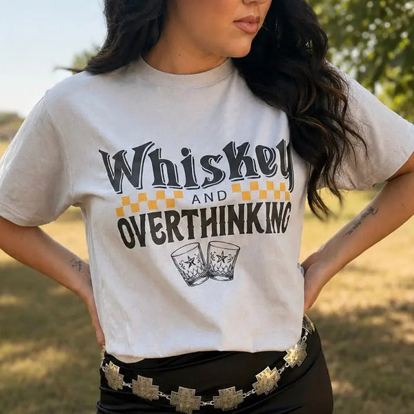 Woman wearing the Whiskey and Overthinking graphic tee in Silver with a black and golden-orange design
