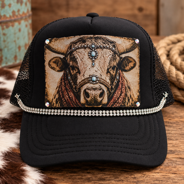 Rhinestone Ranch Cow Trucker Hat in black with vintage cow portrait patch, turquoise accents, rust bandana details, and rhinestone trim