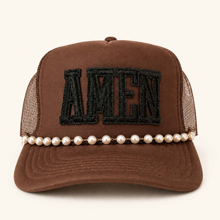 Brown AMEN trucker hat with black glitter patch and pearl brim chain, clean product view