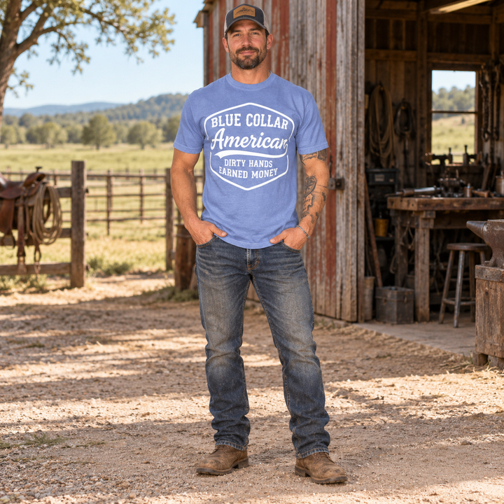 Full-length man wearing Blue Collar American Washed Denim patriotic T-shirt at a Southern ranch workshop