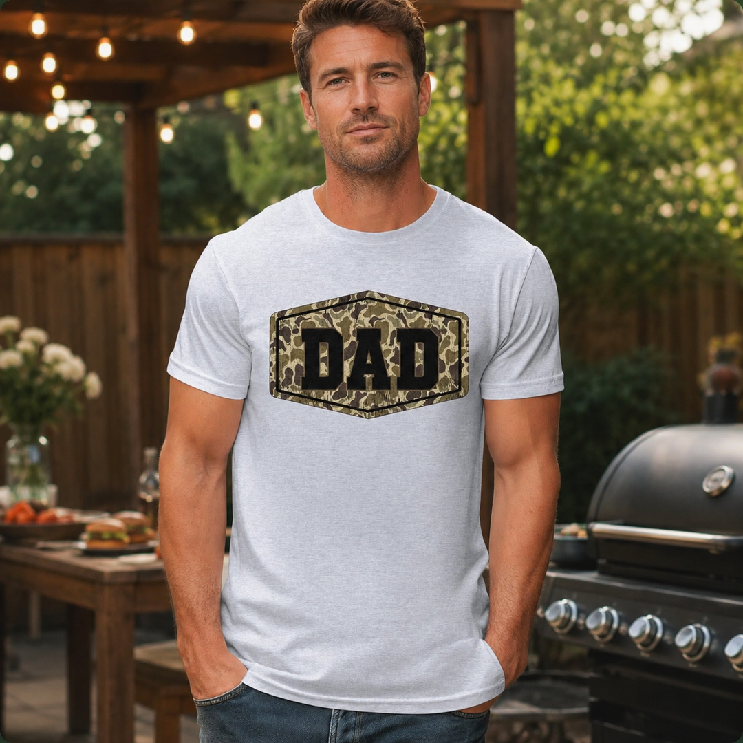 Man wearing the Camo DAD light gray graphic tee at a backyard cookout