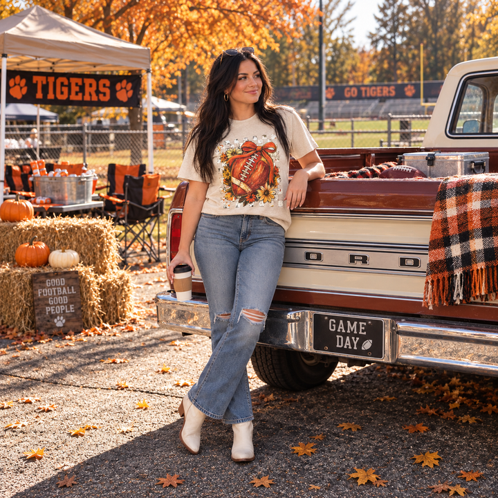 Checkered Floral Football Bow oatmeal tee at small-town tailgate