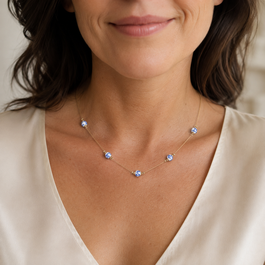 Woman wearing the vintage blue and white chinoiserie five-station dainty necklace