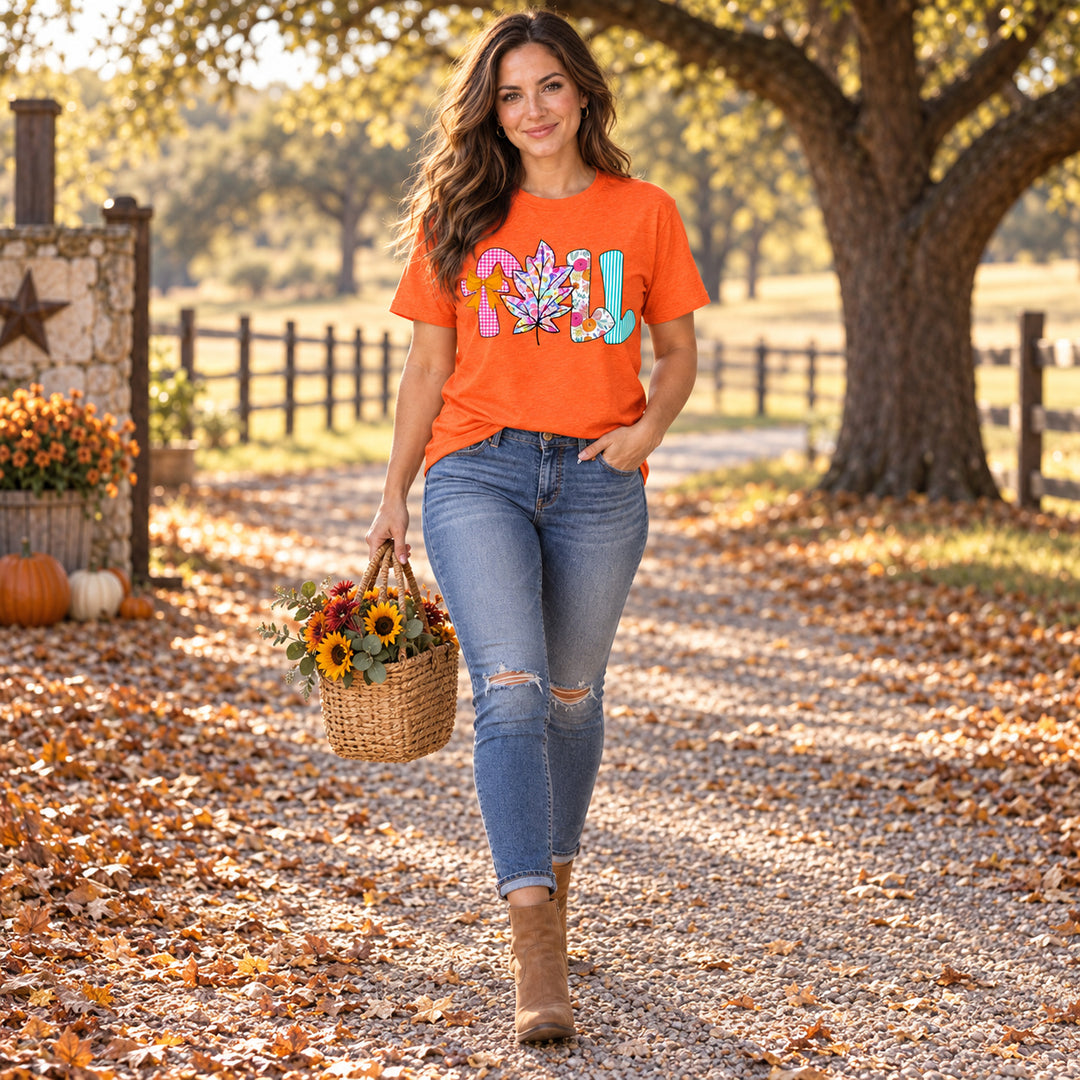 Woman wearing Colorful Fall Leaf Orange Autumn Graphic Tee on a Central Texas ranch lane