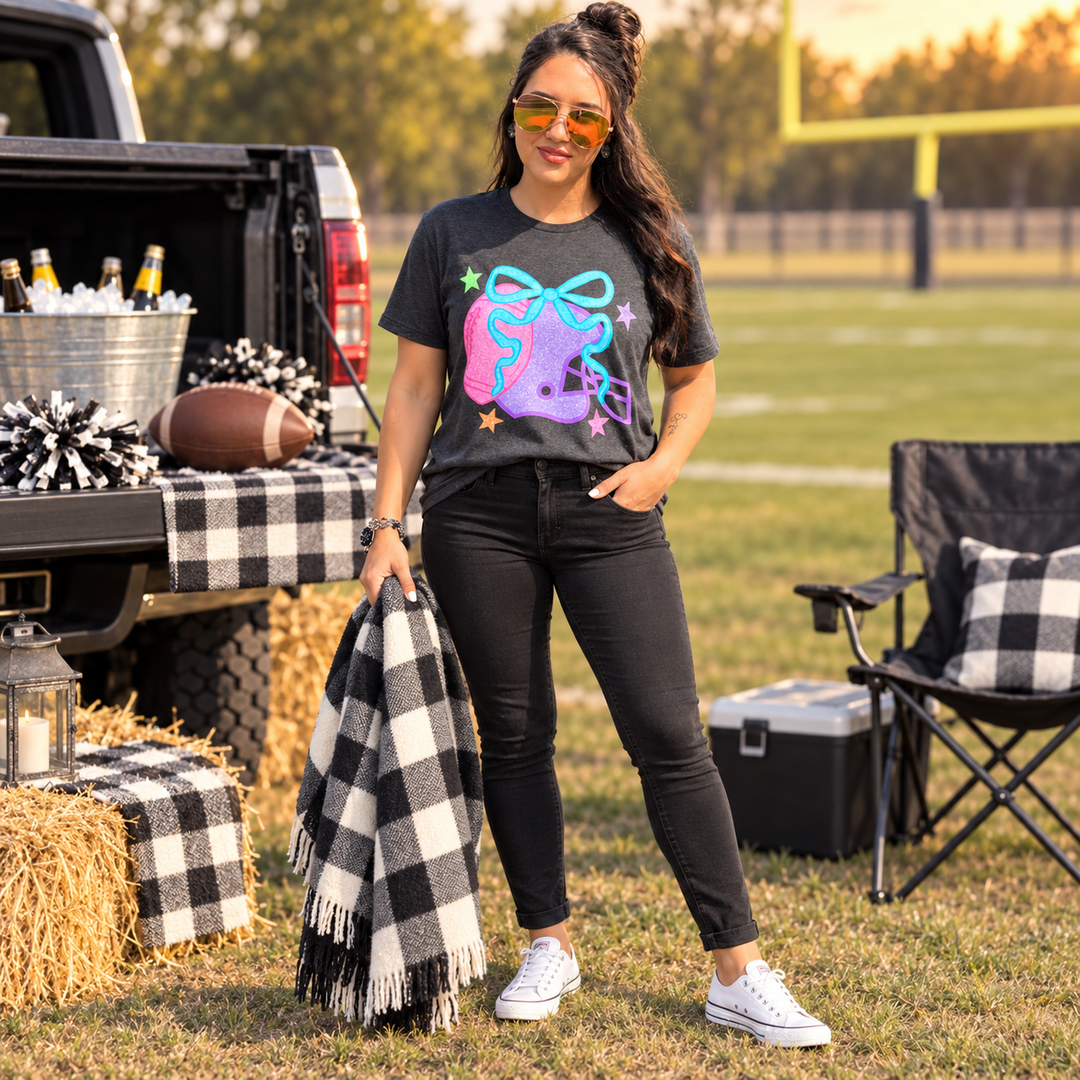 Woman wearing Colorful Football Helmet graphite graphic tee at a small-town tailgate