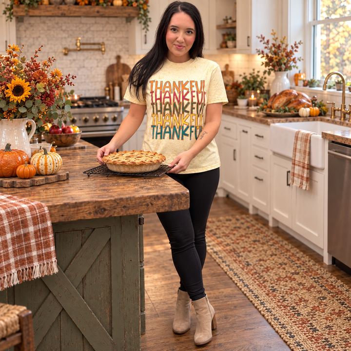 Woman wearing Colorful Thankful Citrine Thanksgiving Graphic Tee while preparing pie