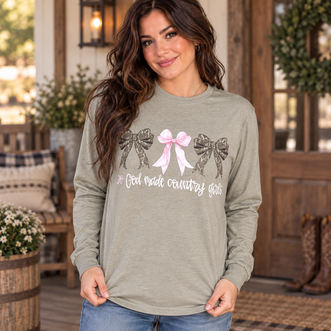 Woman wearing the sage So God Made Country Girls long-sleeve tee in a close Western portrait