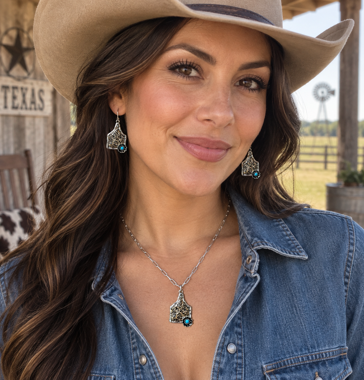 Woman wearing Cow Tag Flower Western necklace and earrings at a Texas ranch