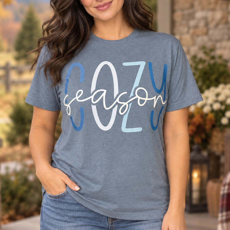 Brunette wearing the blue-grey Cozy Season graphic T-shirt in a close Western portrait