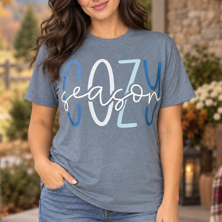 Brunette wearing the blue-grey Cozy Season graphic T-shirt in a close Western portrait