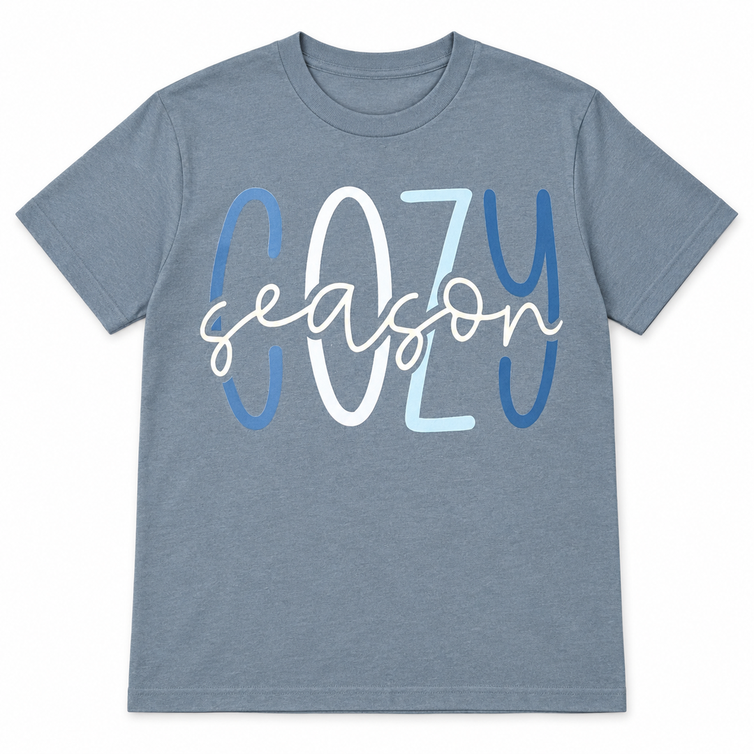 Blue-grey Cozy Season graphic T-shirt laid flat on pure white