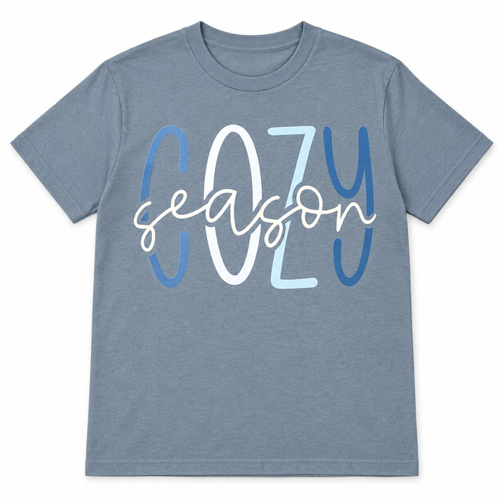 Blue-grey Cozy Season graphic T-shirt laid flat on pure white