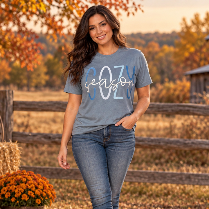 Full-body brunette wearing the Cozy Season graphic tee in a Western autumn setting
