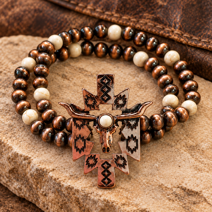 Close styled view of Desert Longhorn Aztec Bracelet with bronze-tone and ivory beads and longhorn skull charm