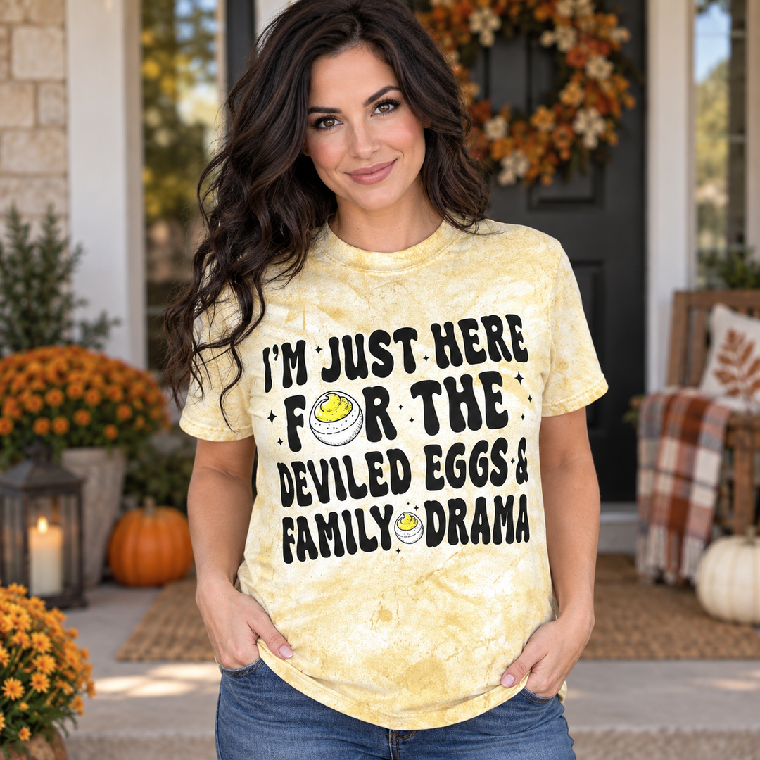 Brunette woman in Deviled Eggs and Drama yellow Thanksgiving tee, complete head and shirt