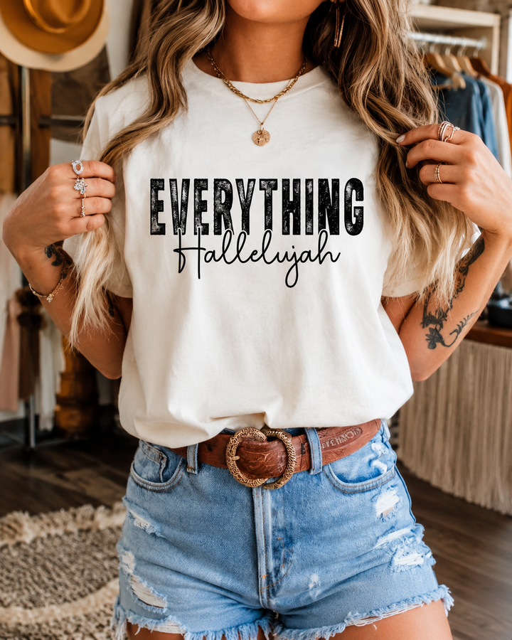 Woman wearing the ivory Everything Hallelujah faith graphic tee