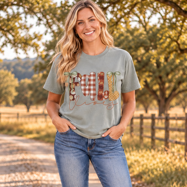 Woman wearing Fall Vibes Bay Comfort Colors graphic tee on a ranch road