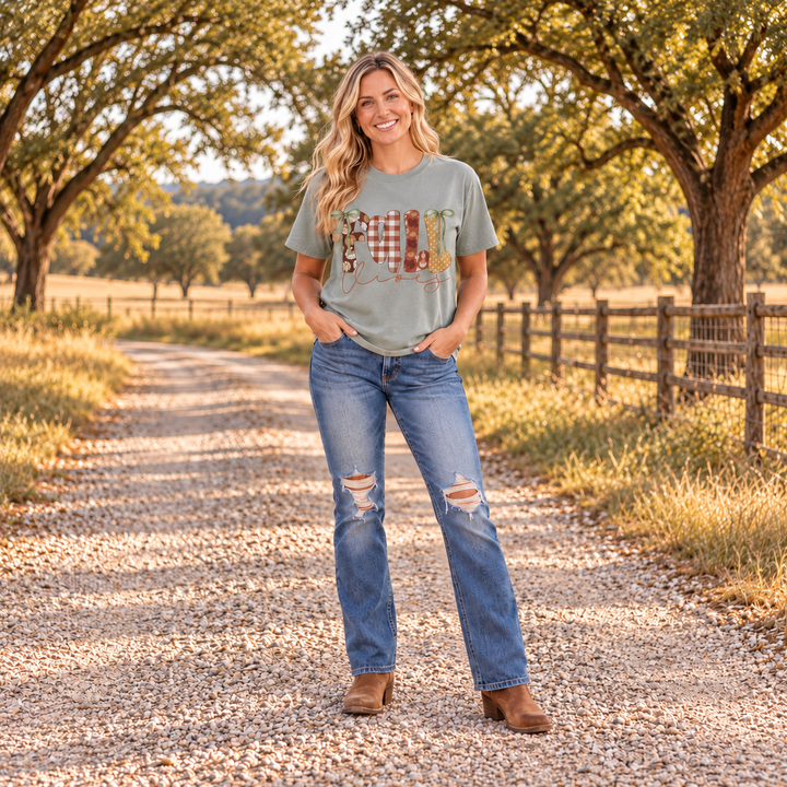 Woman wearing Fall Vibes Bay Comfort Colors graphic tee on a Central Texas ranch road