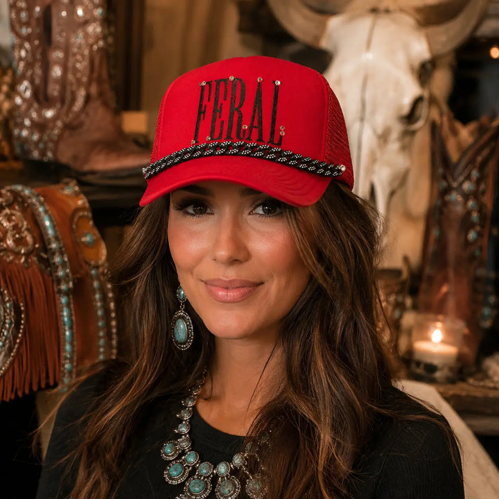 Woman wearing a snug red Feral rhinestone Western trucker hat