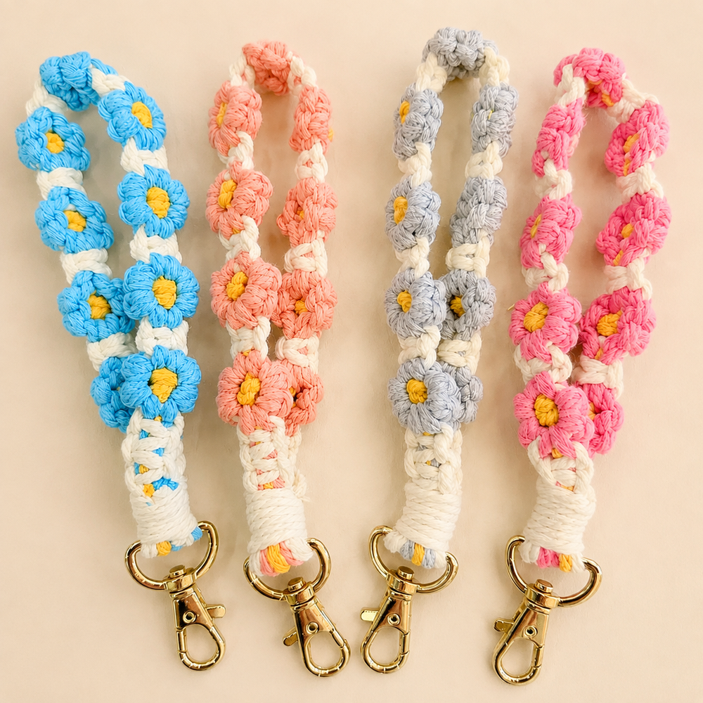 Crocheted floral wristlet keychains in blue, peach, gray, and neon pink with gold clasps