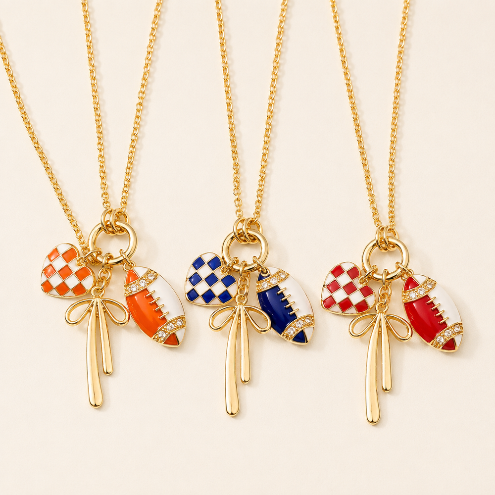 Football bow charm necklaces in orange, blue, and red enamel with gold-tone chains