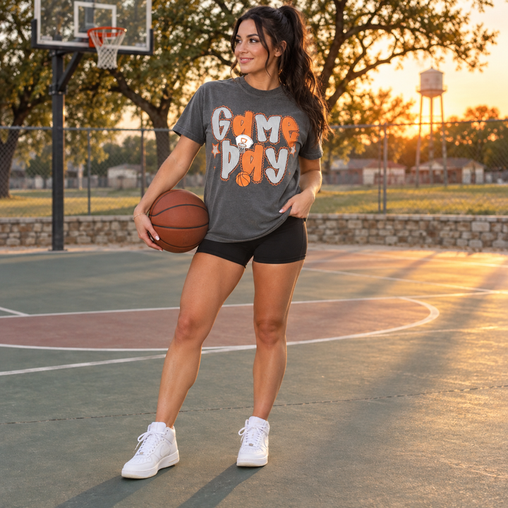 Woman wearing Game Day Basketball Pepper graphic tee on an outdoor basketball court