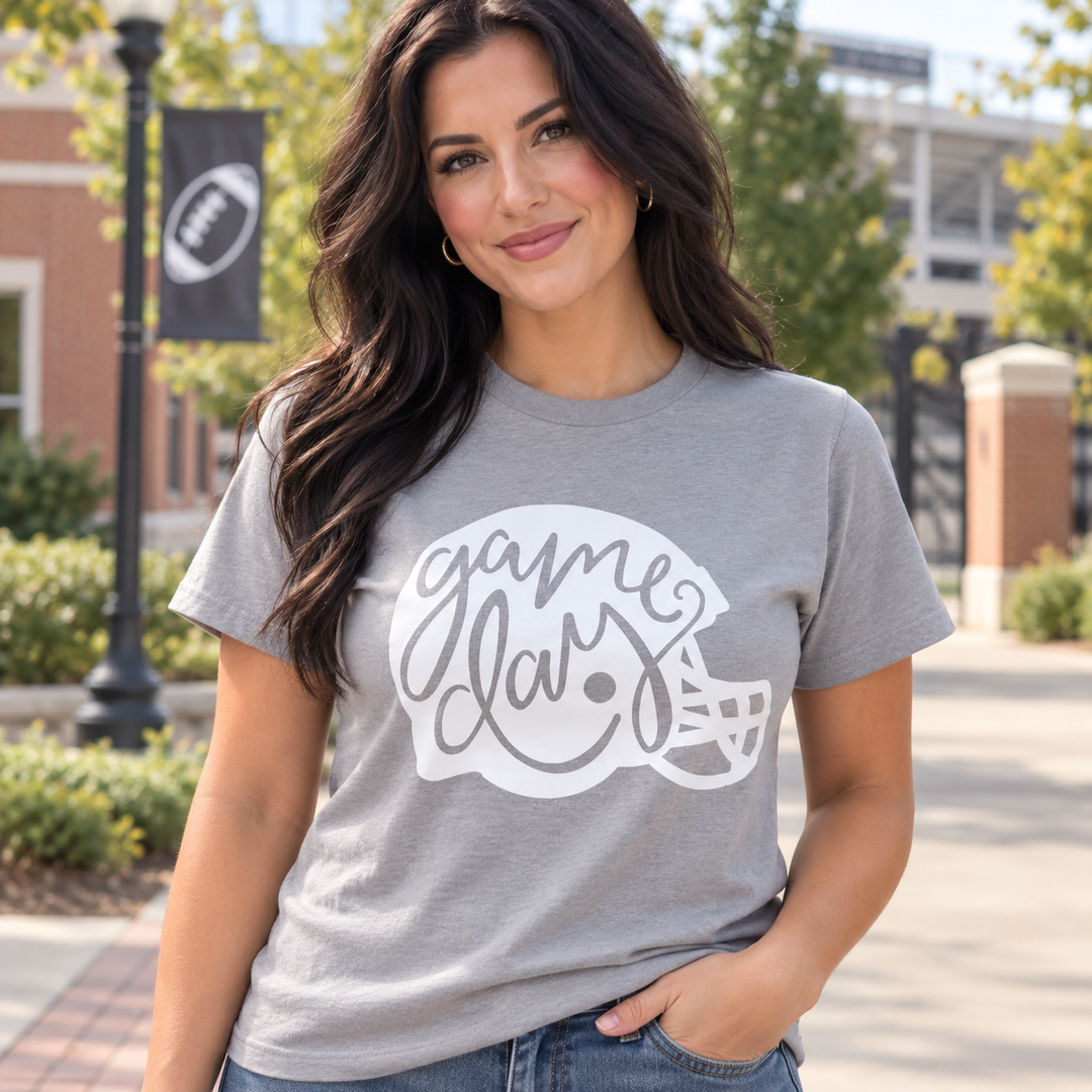 Game Day Helmet gravel football graphic tee on model near college stadium