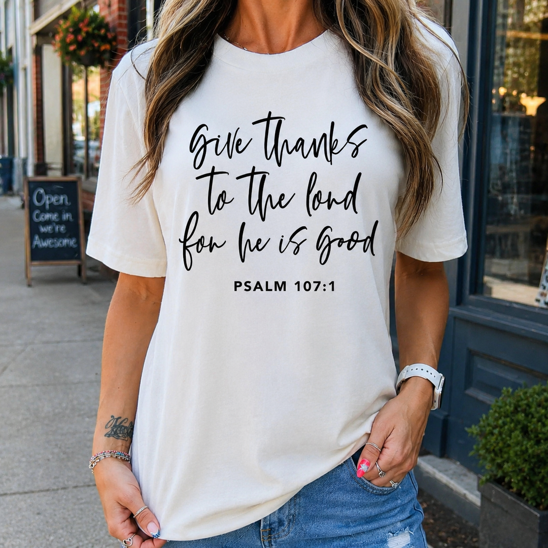 Woman wearing an ivory Give Thanks to the Lord Psalm 107:1 graphic tee