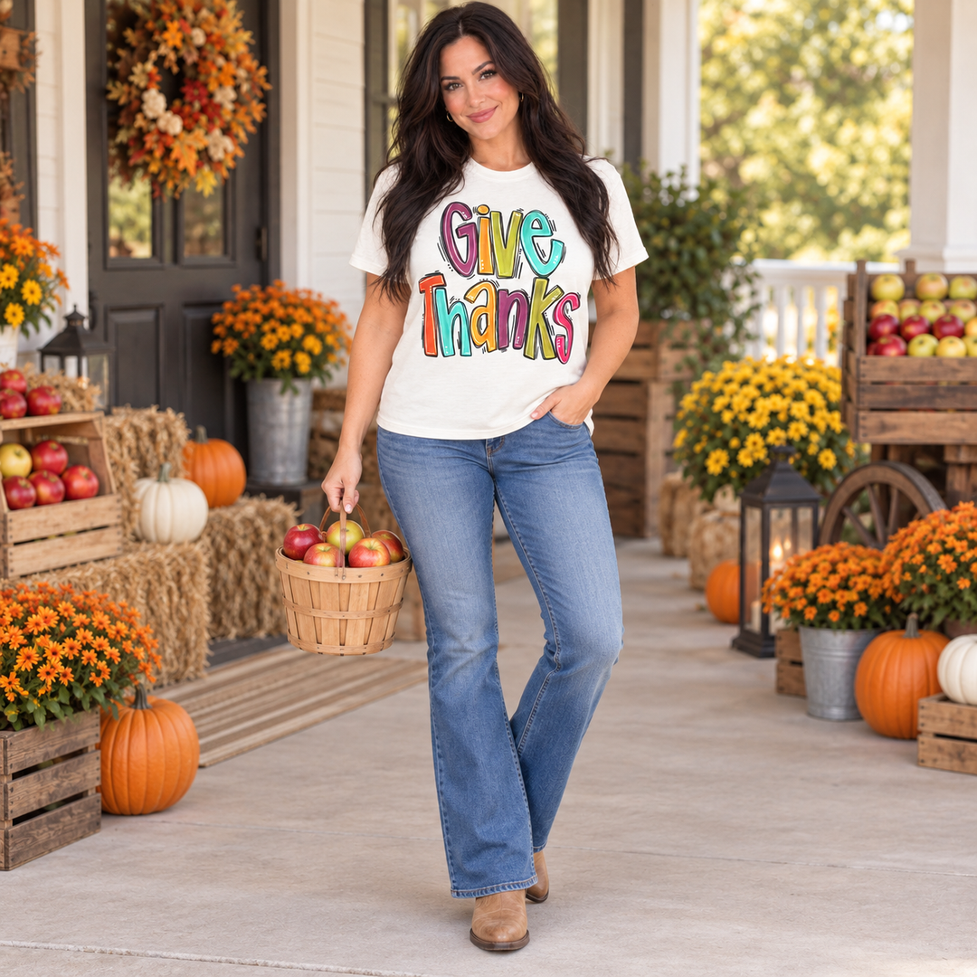 Woman wearing Give Thanks natural graphic tee at a small-town harvest market