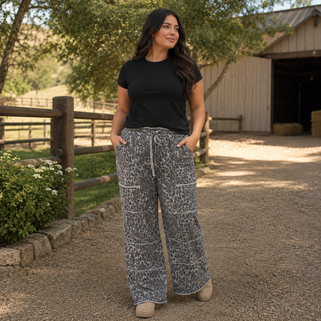 Woman wearing gray leopard wide-leg lounge pants with cargo pockets