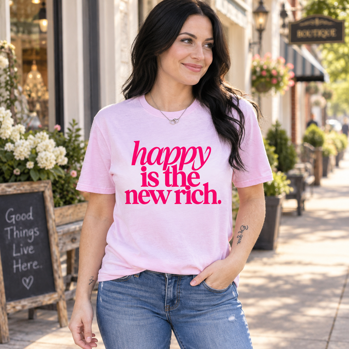 Woman wearing Happy Is the New Rich light pink graphic tee