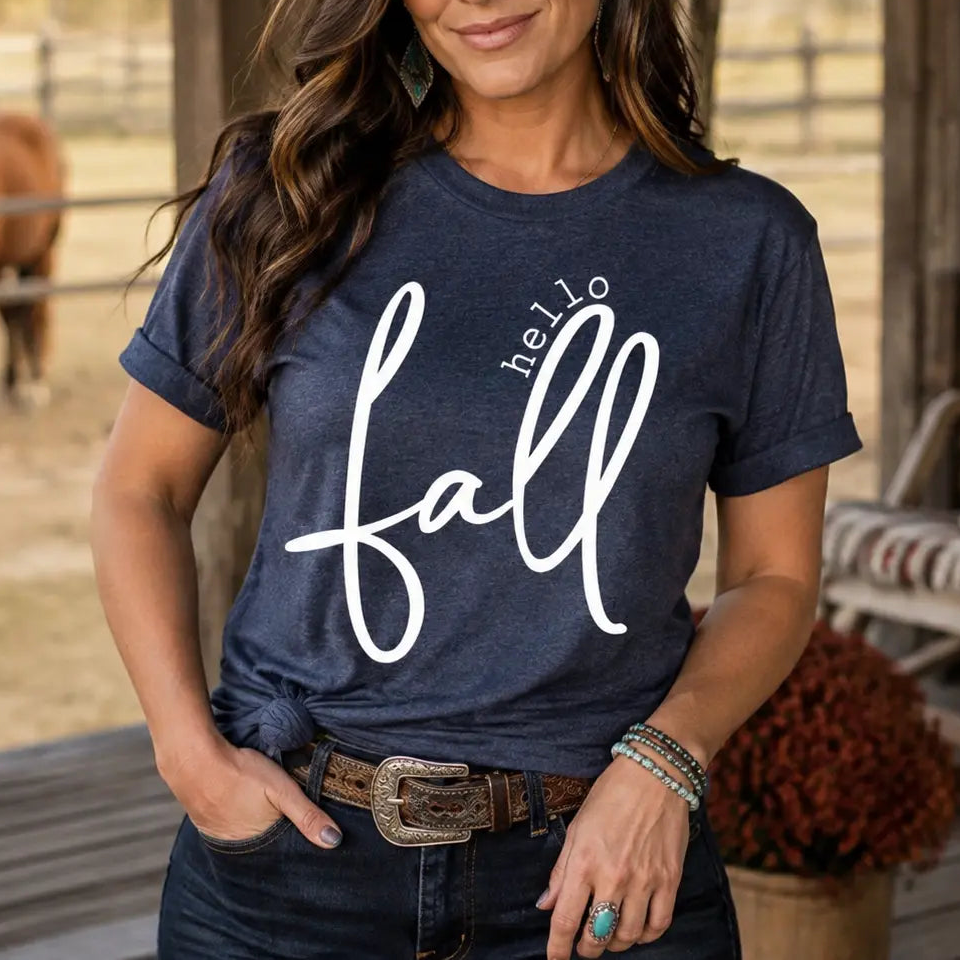 Woman wearing the Hello Fall heather navy graphic tee on an autumn ranch porch