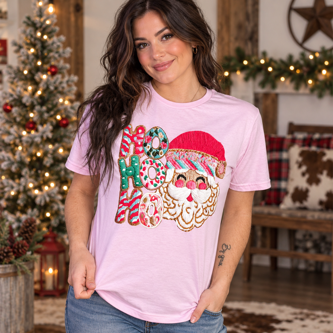 Woman wearing the light pink Ho Ho Ho Yarn Santa Christmas tee in a close Western holiday portrait