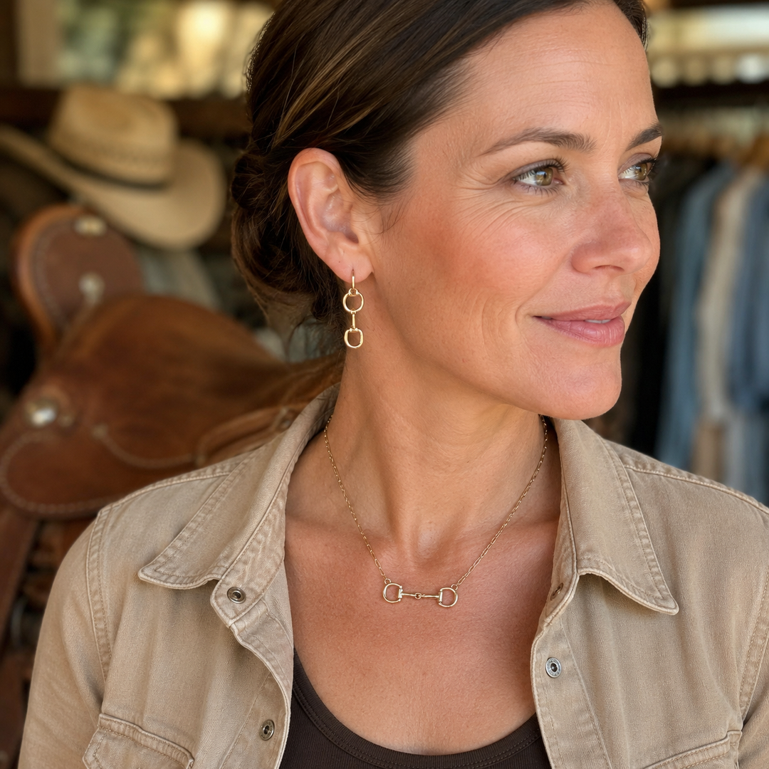 Woman wearing the faux gold horse bit necklace and matching linked-bit earrings
