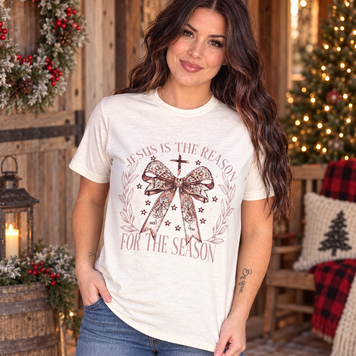 Brunette woman wearing the Jesus Is the Reason light beige Christmas tee in a close country portrait