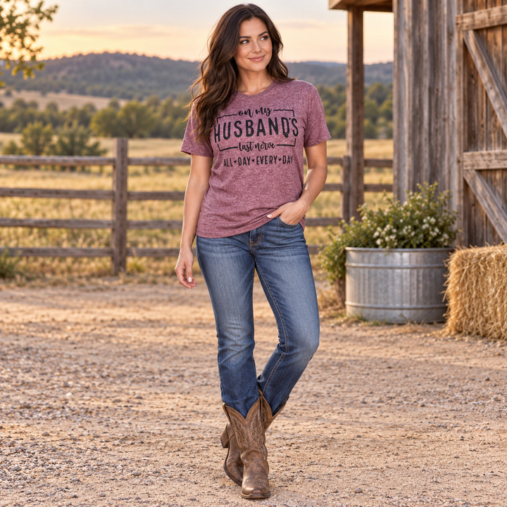 Full-body brunette wearing the Husband’s Last Nerve burgundy tee at a Western ranch
