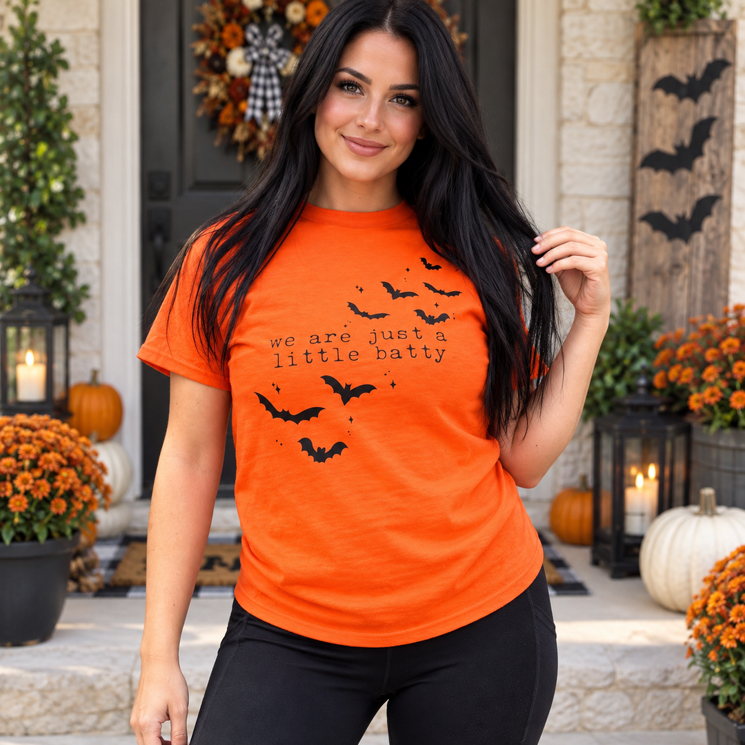 Woman modeling We’re Just a Little Batty orange Halloween tee