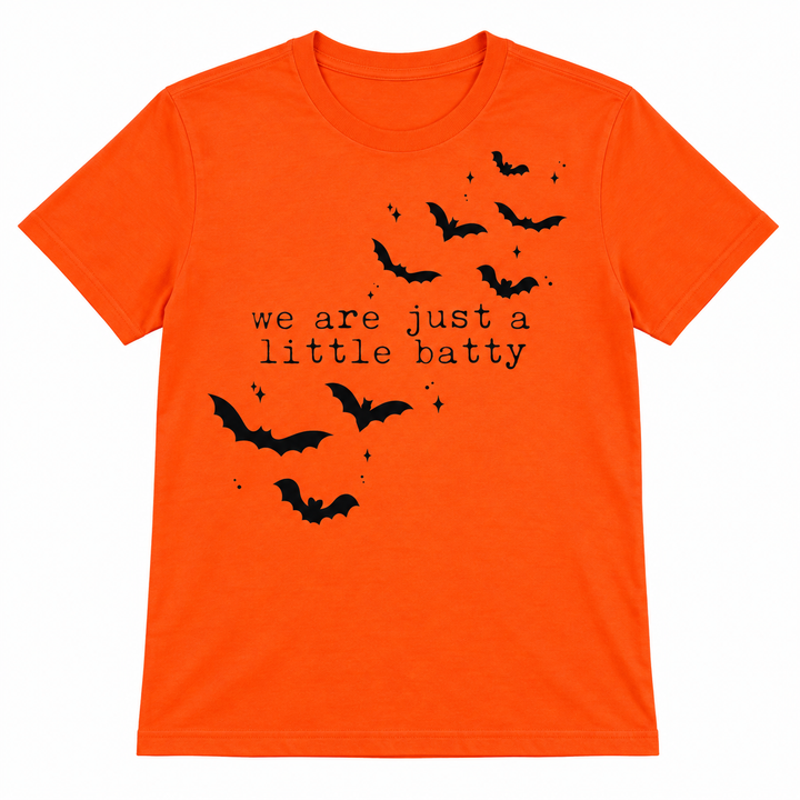 We’re Just a Little Batty orange Halloween tee flat lay on white