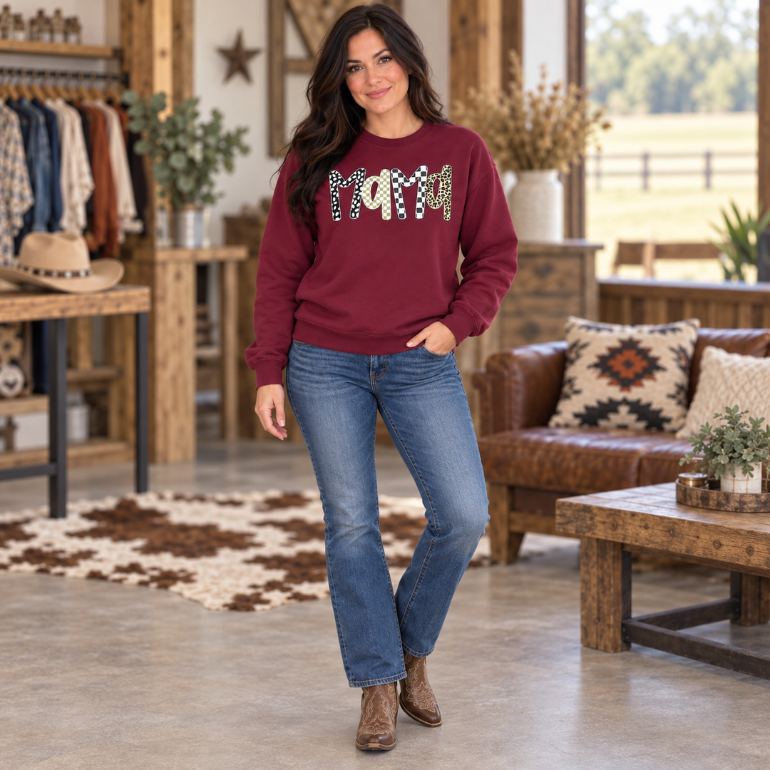 Full-body woman wearing the maroon Mama boho leopard sweatshirt in a Western boutique setting
