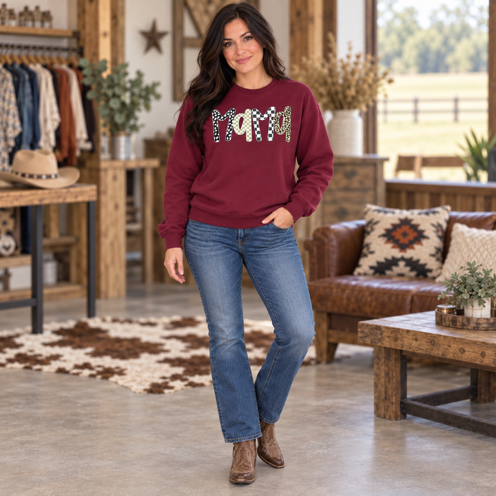 Full-body woman wearing the maroon Mama boho leopard sweatshirt in a Western boutique setting