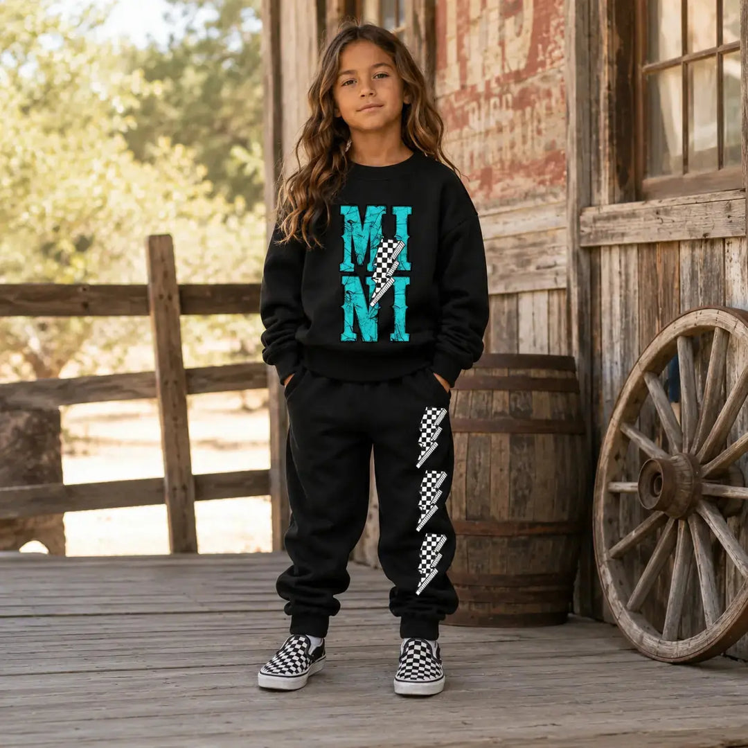 Young model wearing the black MINI Bolt sweatshirt and jogger set
